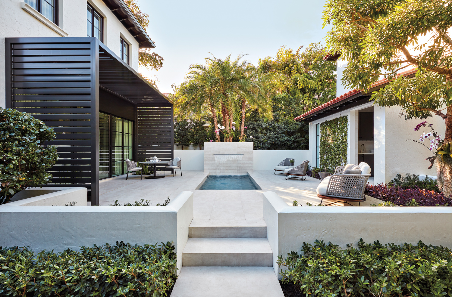 palm beach home back courtyard with aluminum trellis