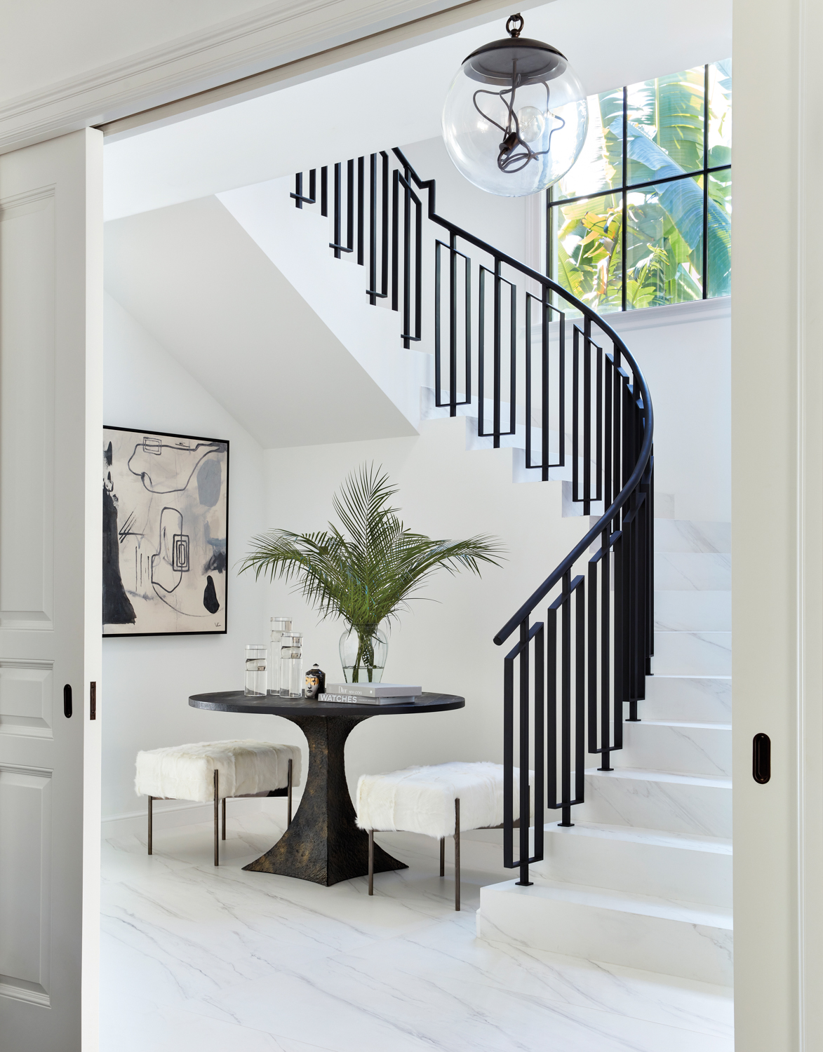 winding staircase with black steel...