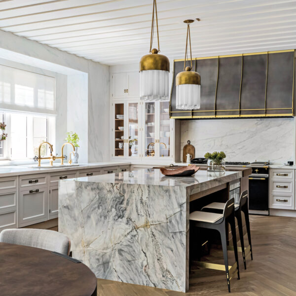 Inside A Soirée-Ready Bay Area Home With A Dazzling Entryway A quartzite countertop with strong veining covers the top and sides of the kitchen island.