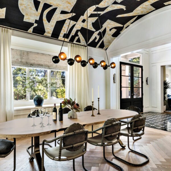 Inside A Soirée-Ready Bay Area Home With A Dazzling Entryway A geometric, black-and-white wallpaper covered the barrel ceiling in the dining room.