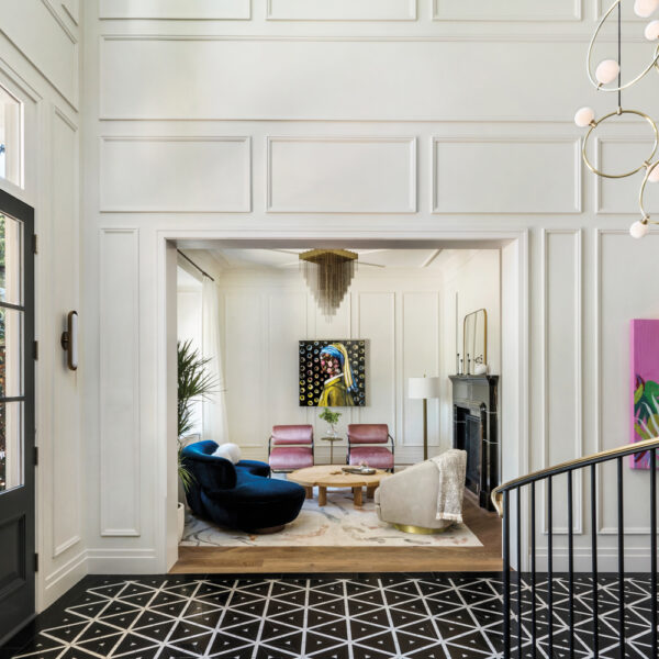 The floor of a home's entry is covered in bold black-and-white tile.