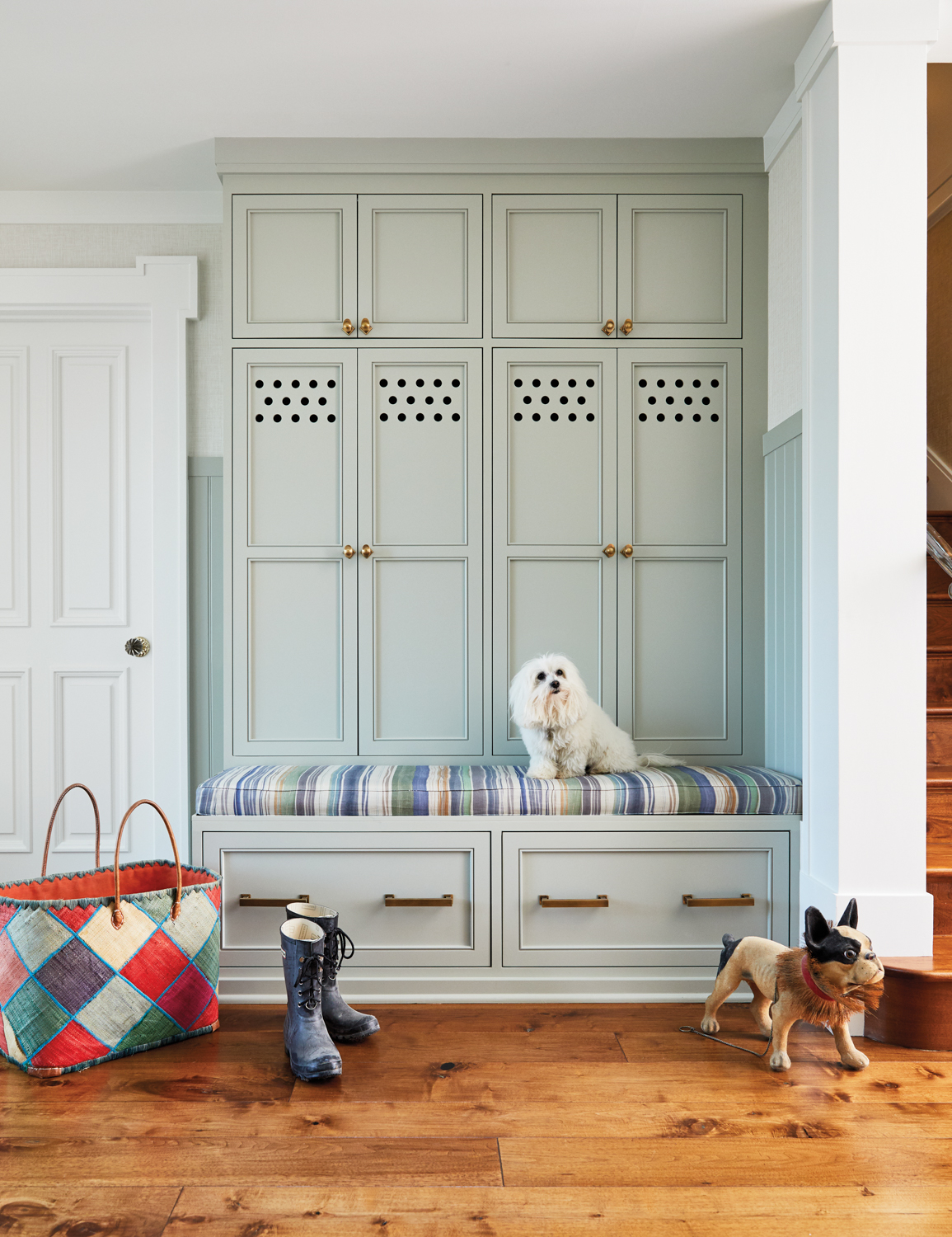 An elegant mudroom features seating...