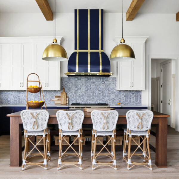Rustic Kitchen With Dark Blue Vent Hood And Patterned Tile Backsplash