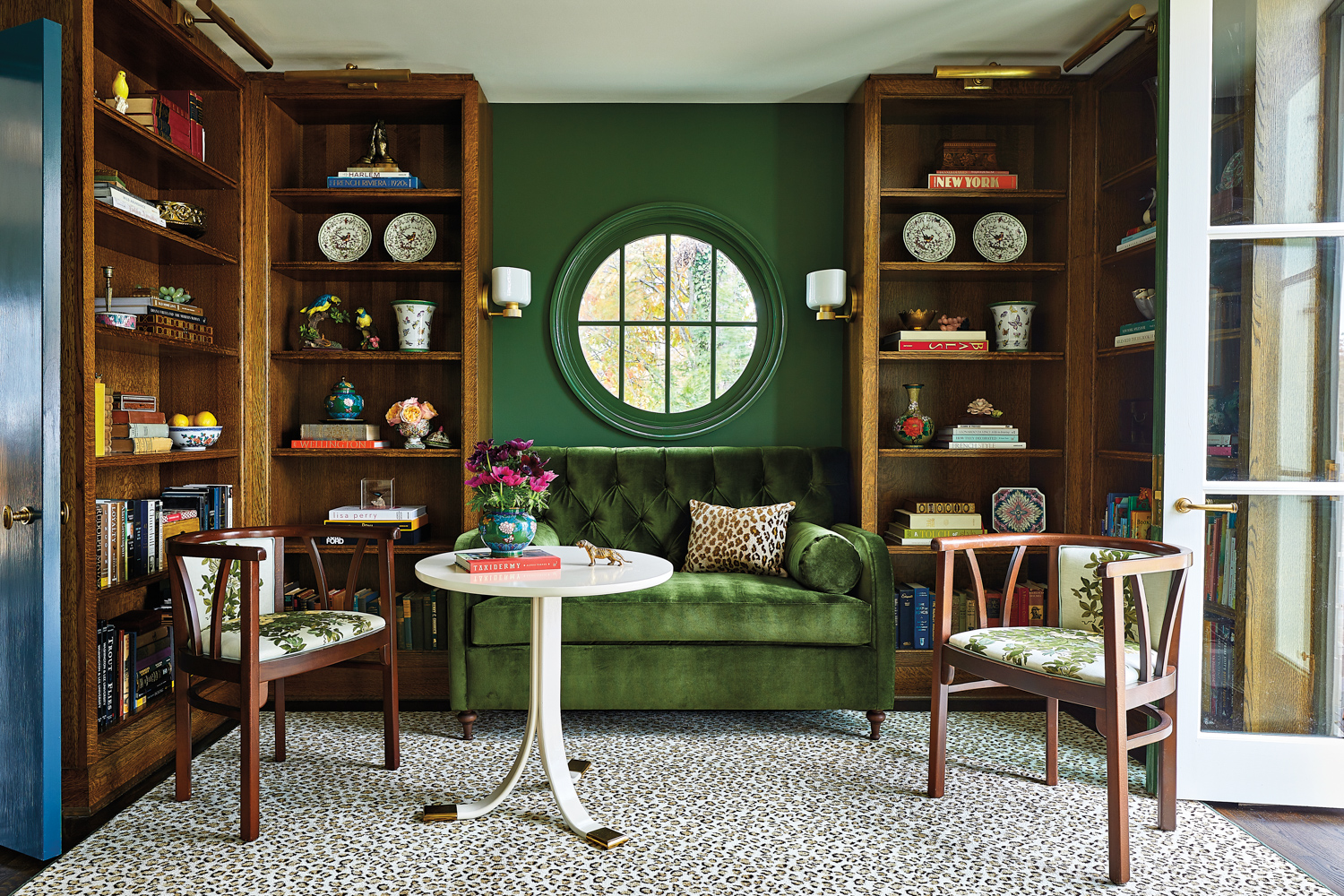 green library with white-oak built ins and velvet settee