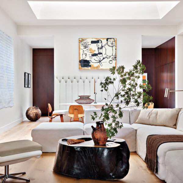 Open-format living room with cream-colored upholstery and large skylight