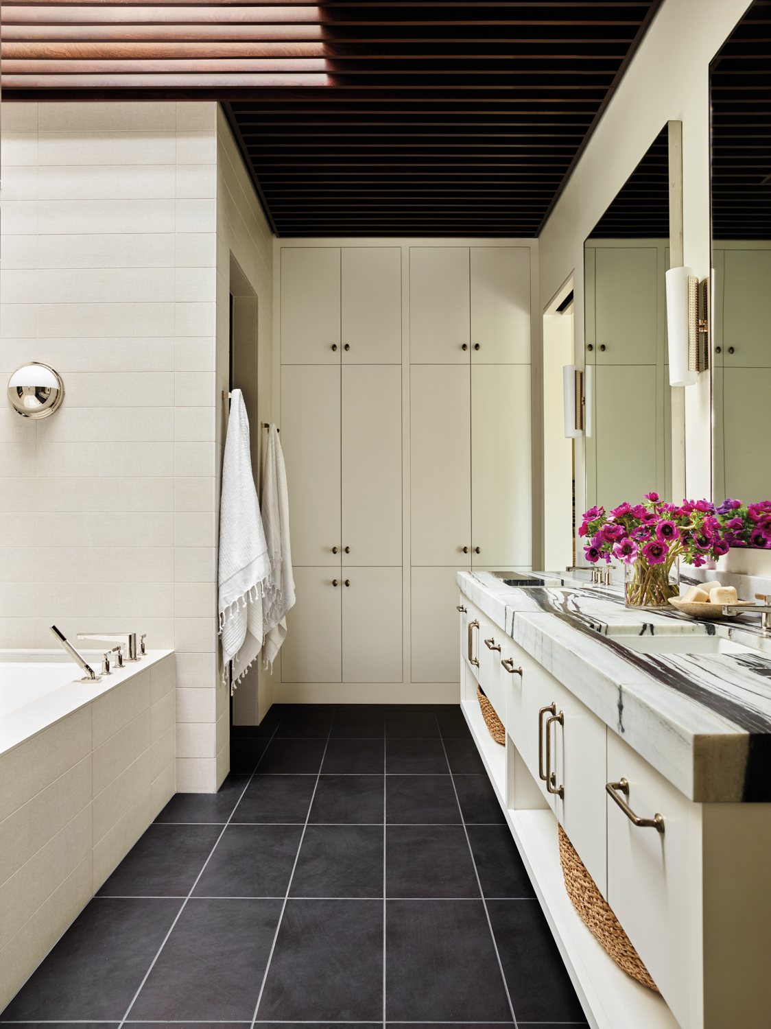 Bathroom with cream-colored built-in cabinetry...