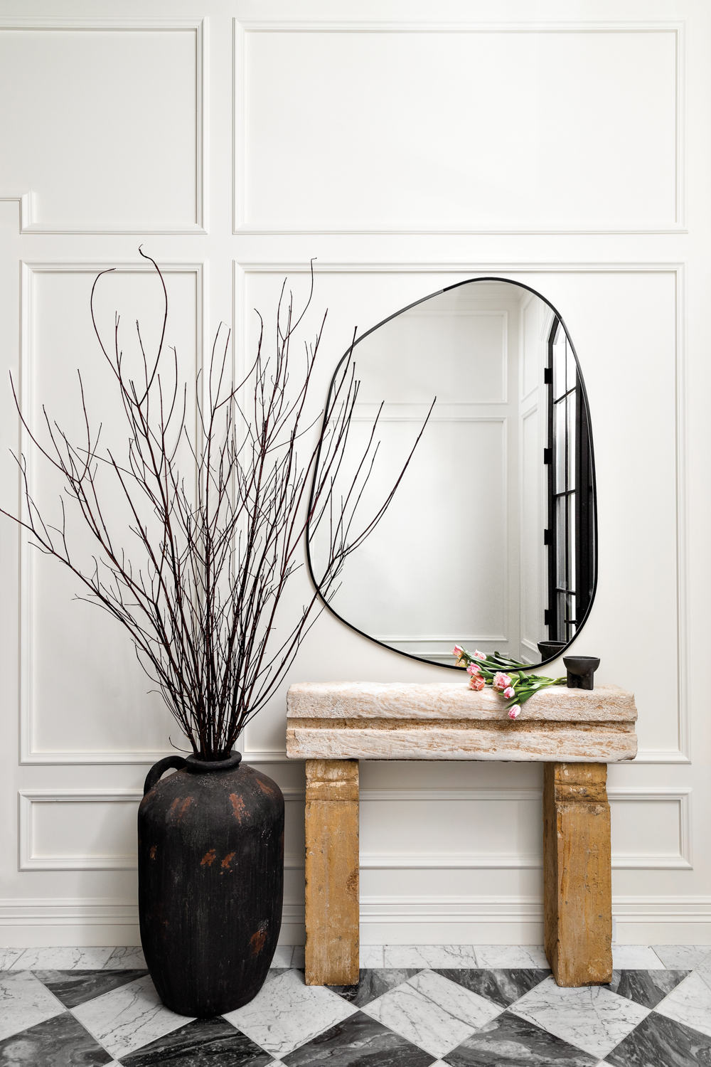 An entryway with a black-and-white...