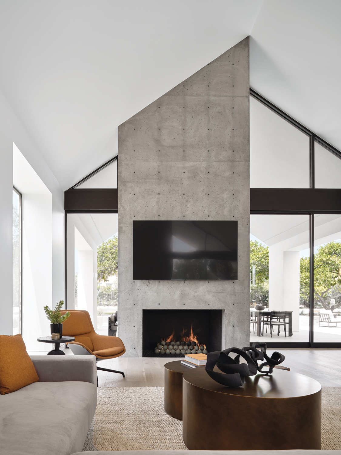 Living room with concrete fireplace.