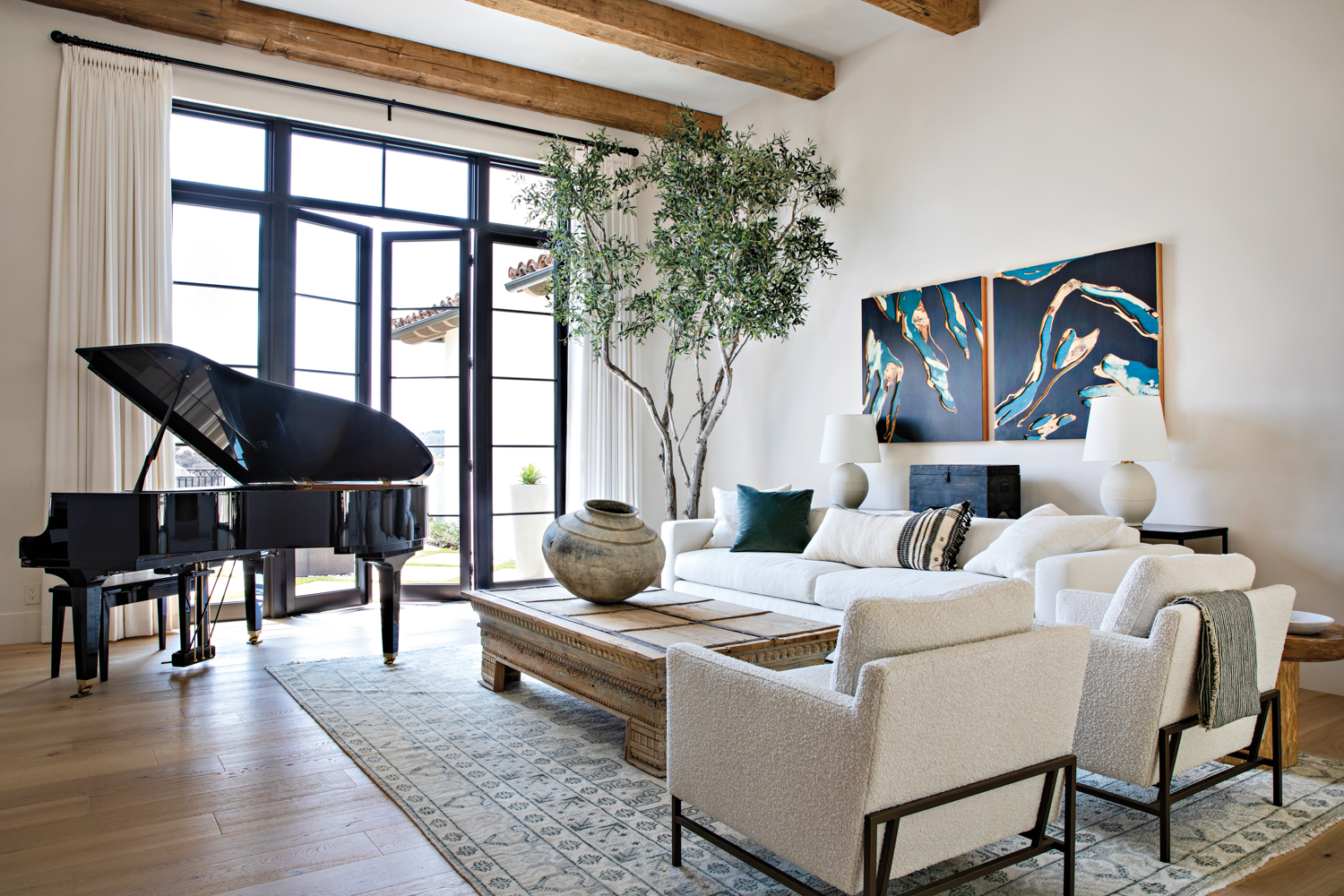 living room with baby grand piano, exposed wooden beams, white furnishings