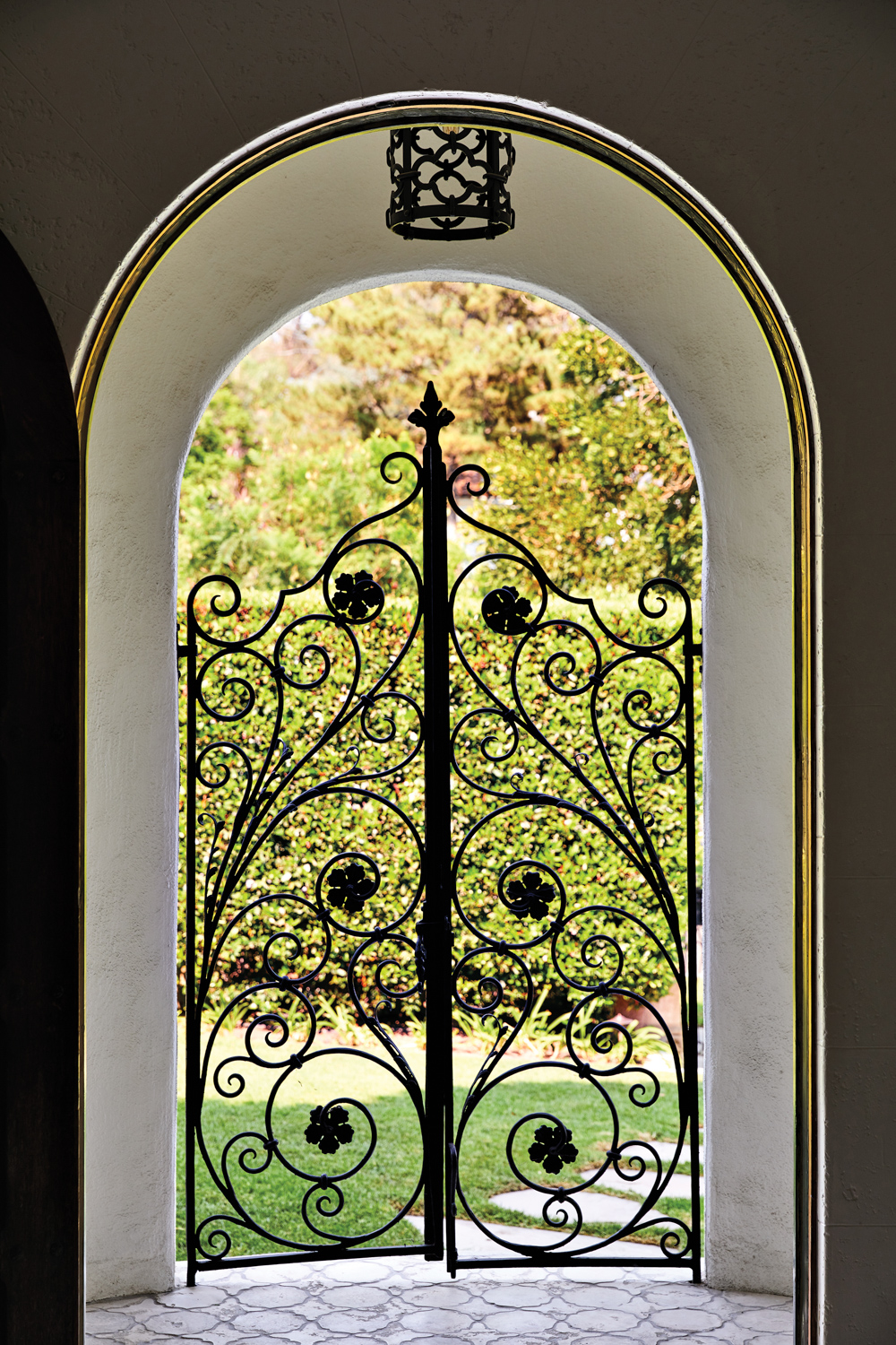 wrought-iron entrance gate under arched...