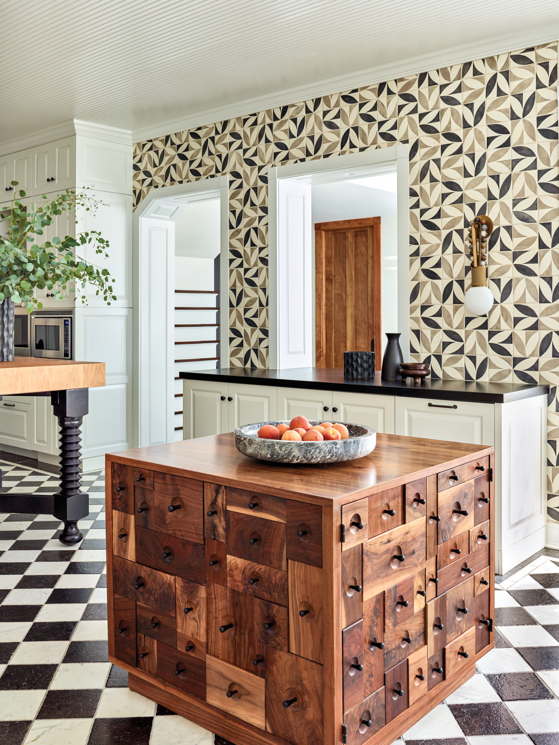 A kitchen with black-and-white checkered...