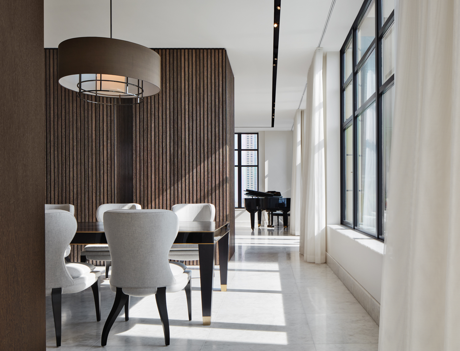 A dining room with wood-slatted walls.