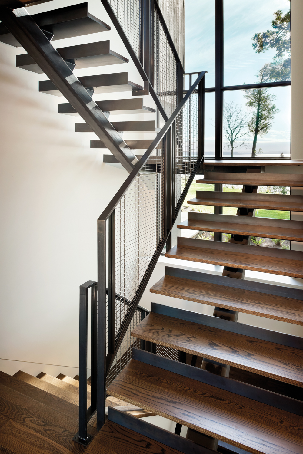 A central staircase has glass...