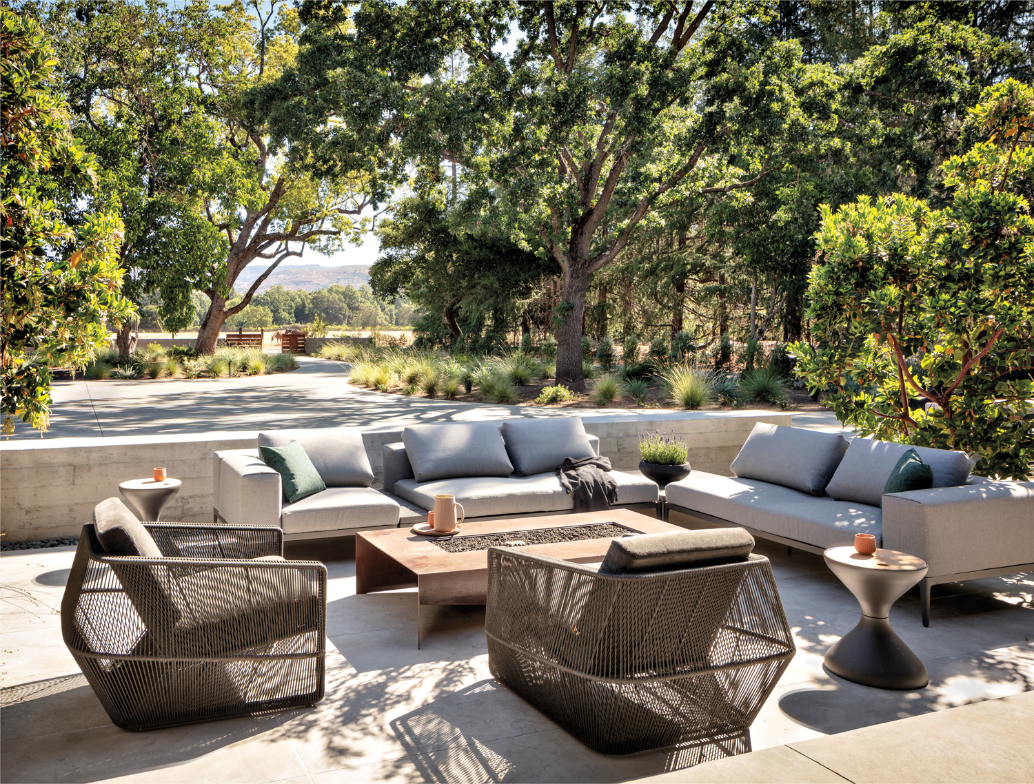 plush seating arranged around a fire pit with lush landscape views is good garden inspiration