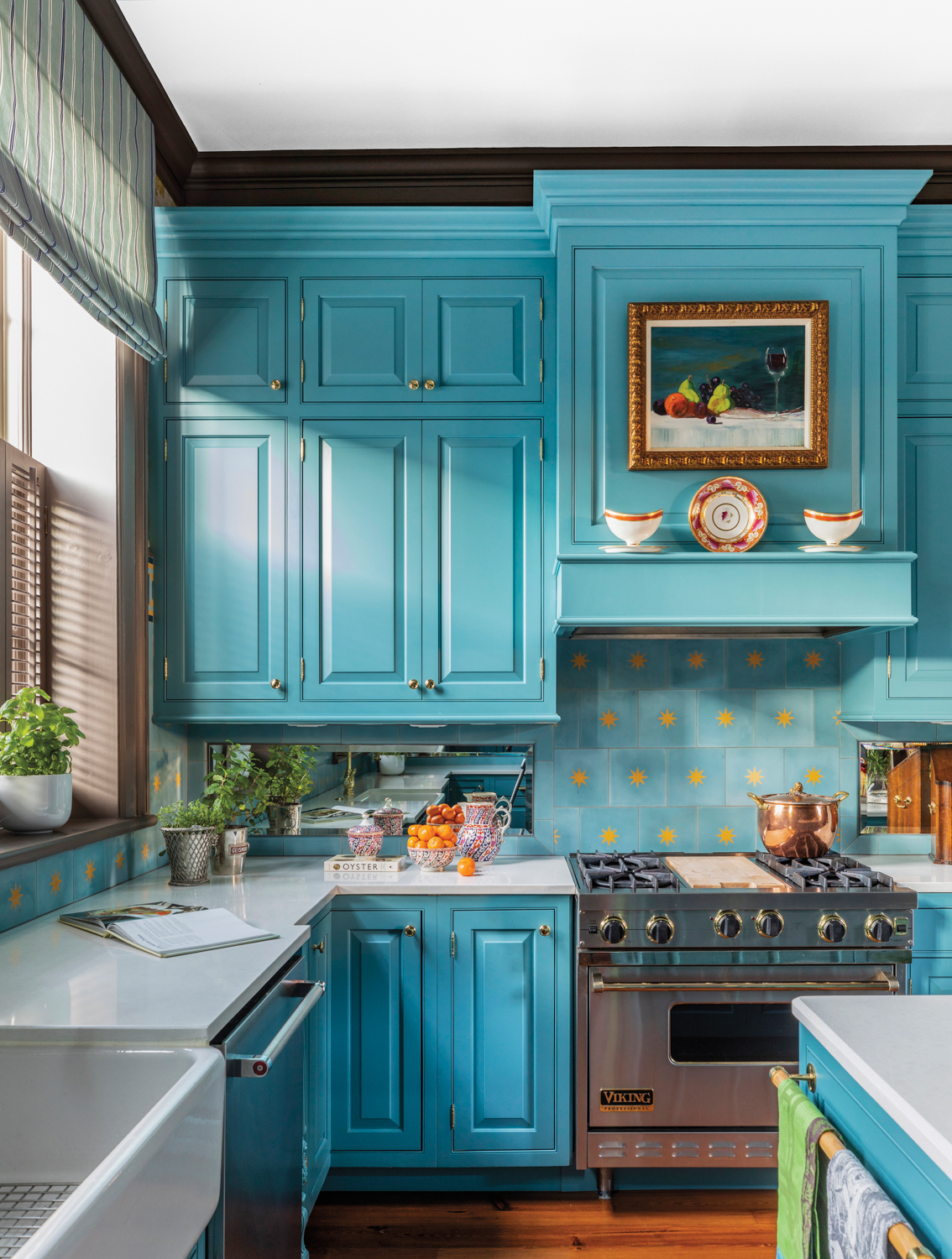 Traditional kitchen with turquoise cabinetry, a still life painting and start-patterned backsplash tile