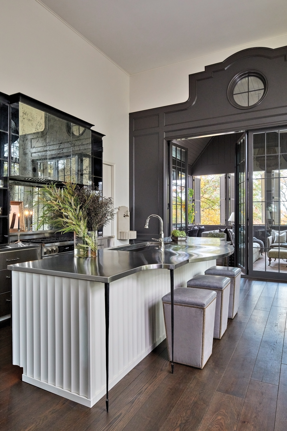 Industrial-inspired kitchen with antiqued mirror...
