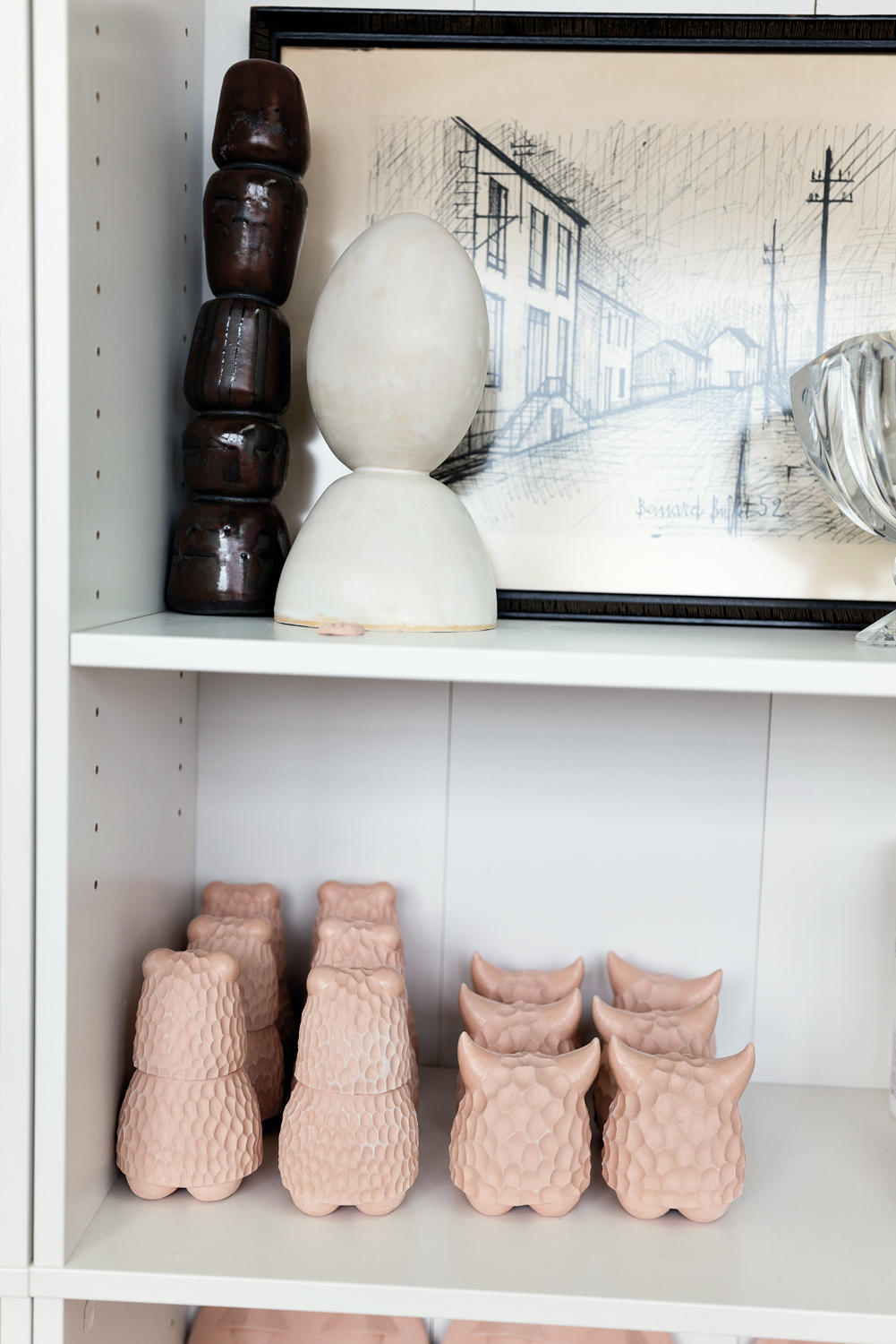 Shelves lined with pottery pieces and artwork