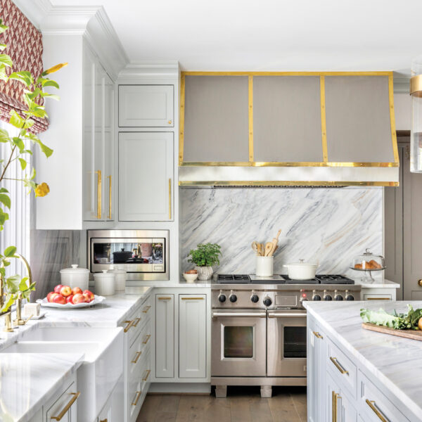 Take A Spin Around The Color Wheel In This Vibrant Houston Gem white kitchen with quartzite countertops and a colorful window shade
