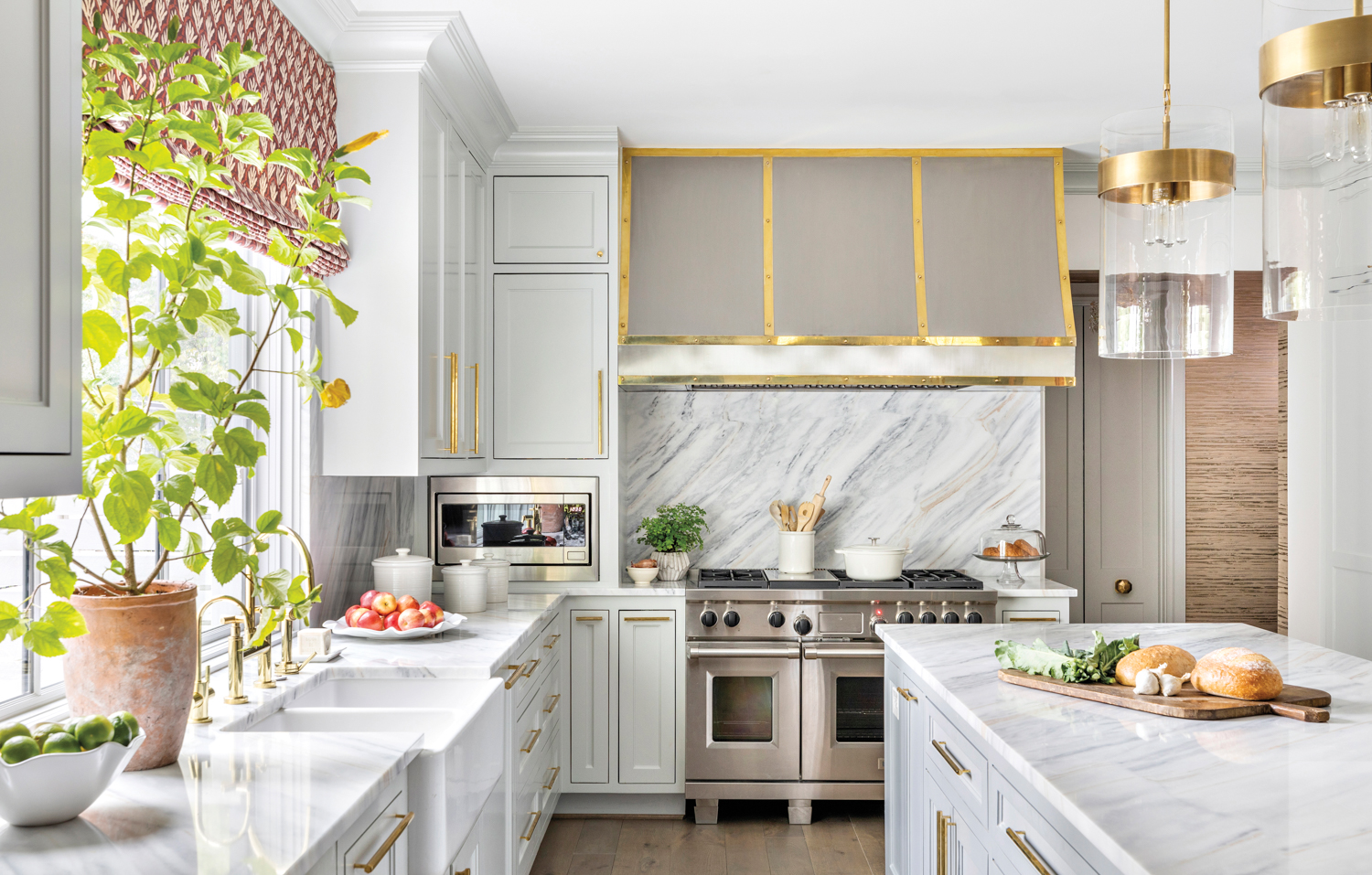 white kitchen with quartzite countertops and a colorful window shade