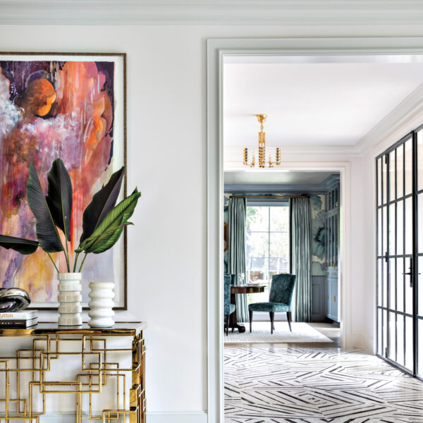 Take A Spin Around The Color Wheel In This Vibrant Houston Gem living room vignette featuring abstract art and a gold console with view of entry featuring marble flooring