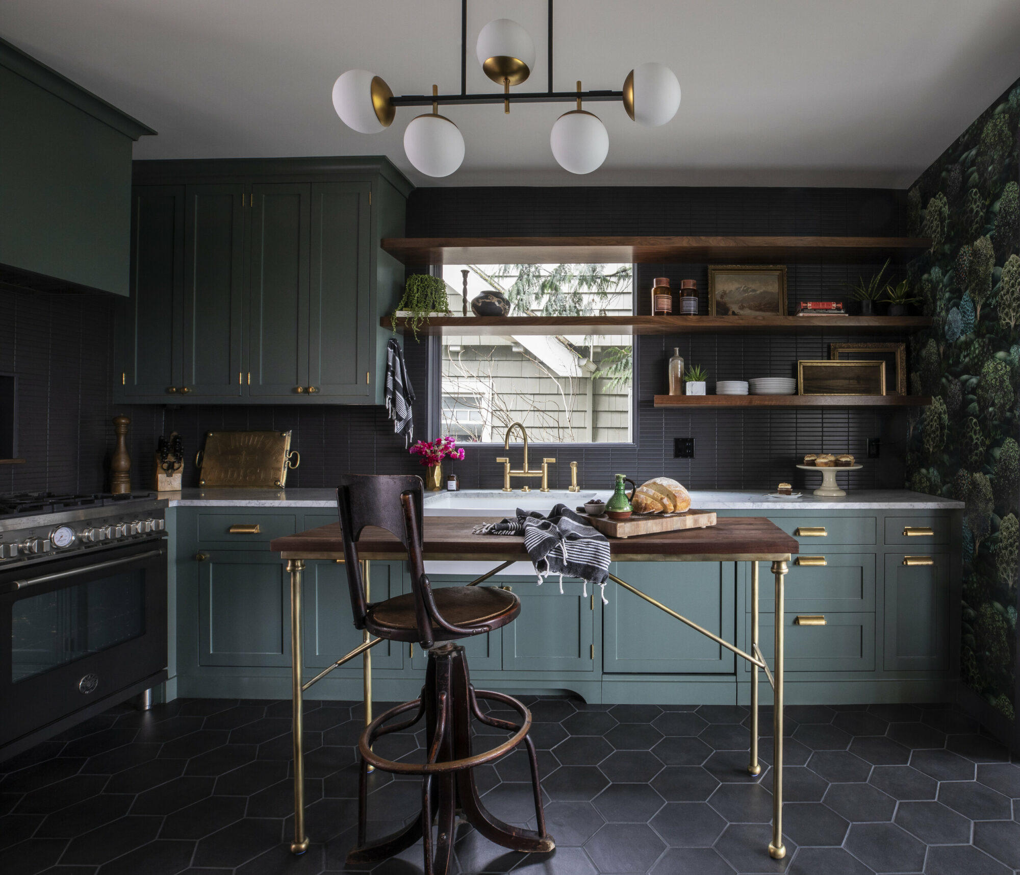 kitchen with dark green cabinetry, black tile flooring and wood table and chair