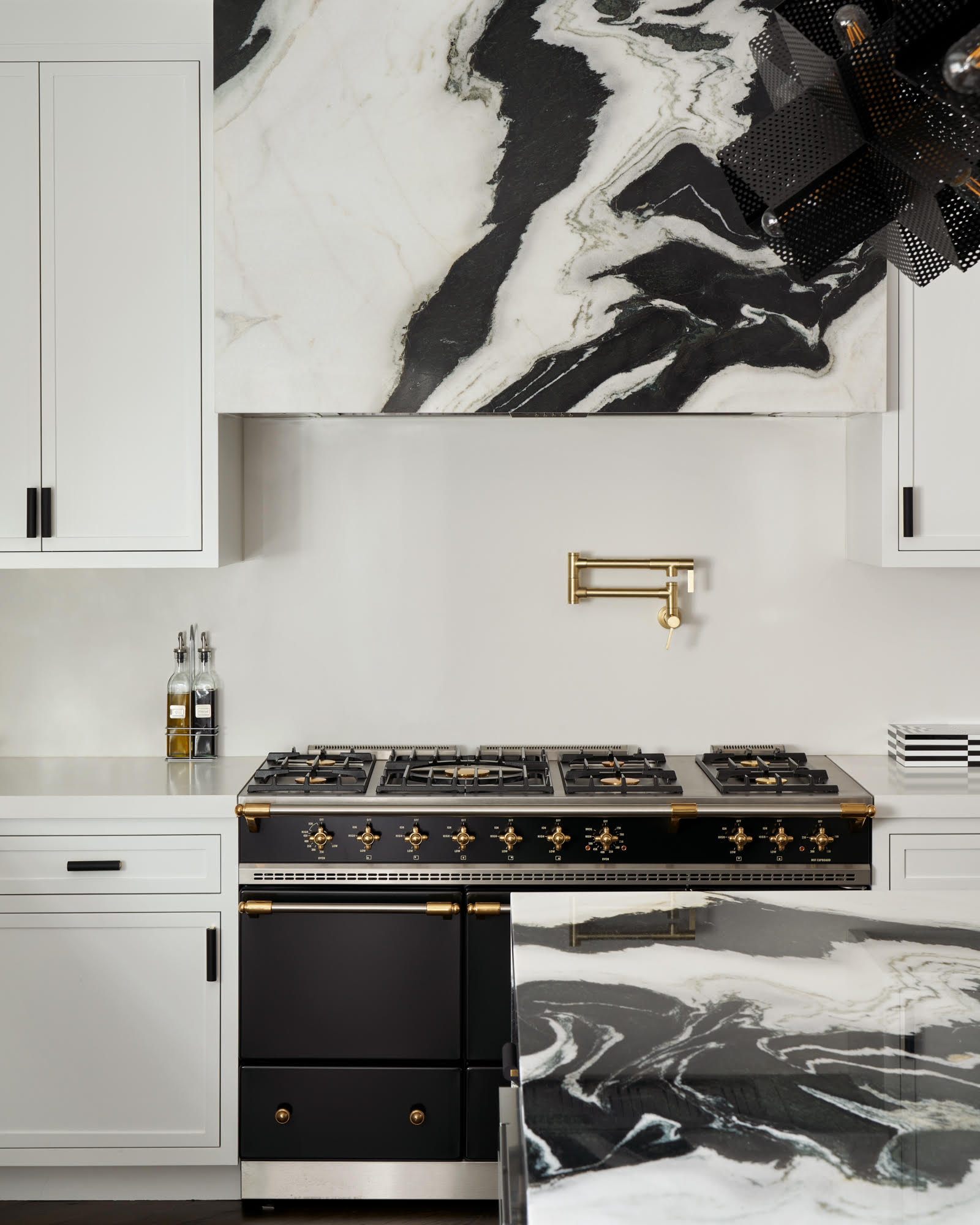 2022 kitchen designs black and white statement marble hood and range 