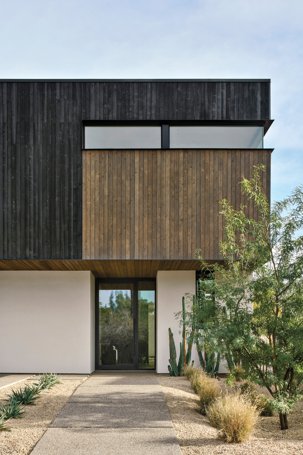 The exterior of modern home with charred cedar siding.
