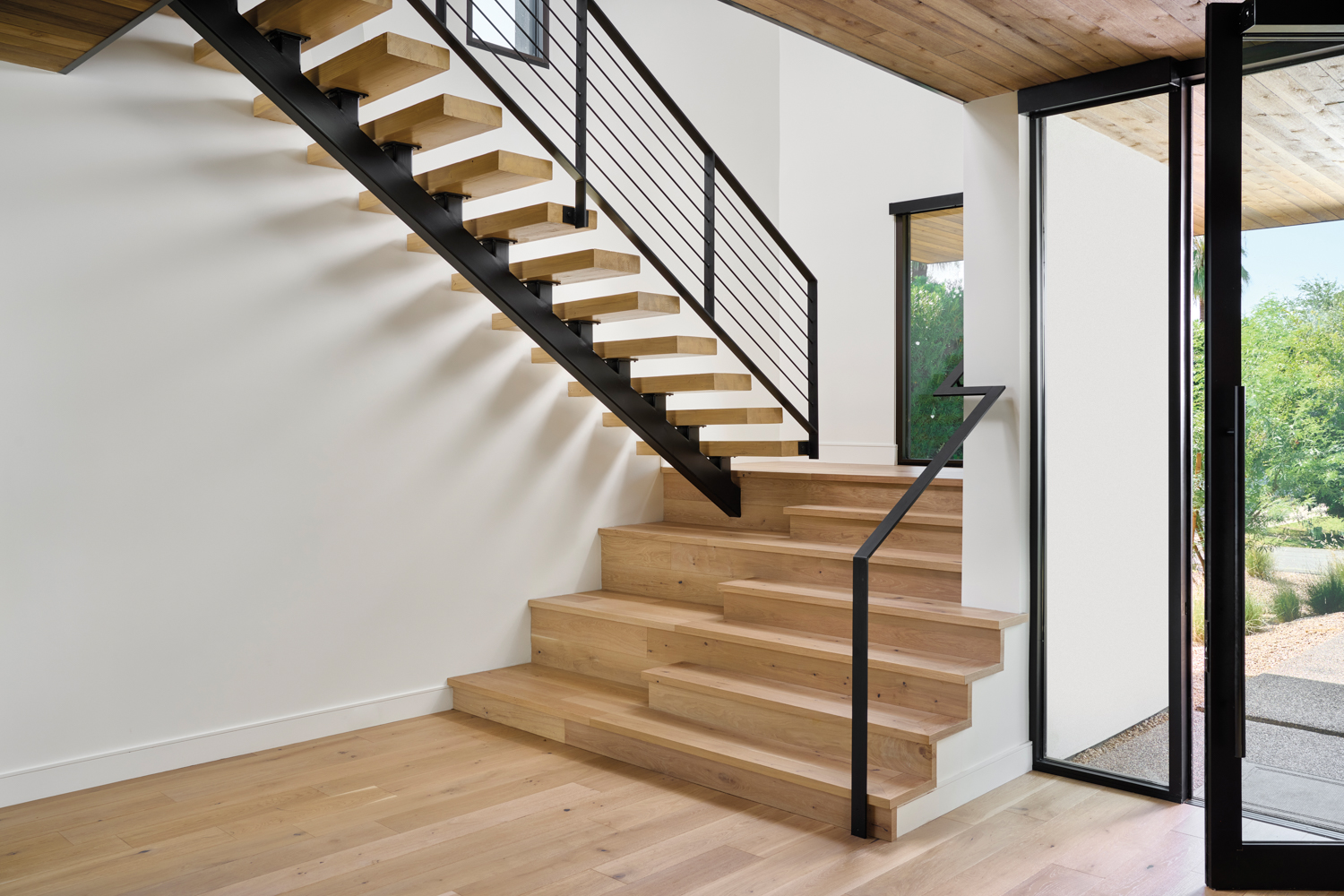 A light oak staircase with...