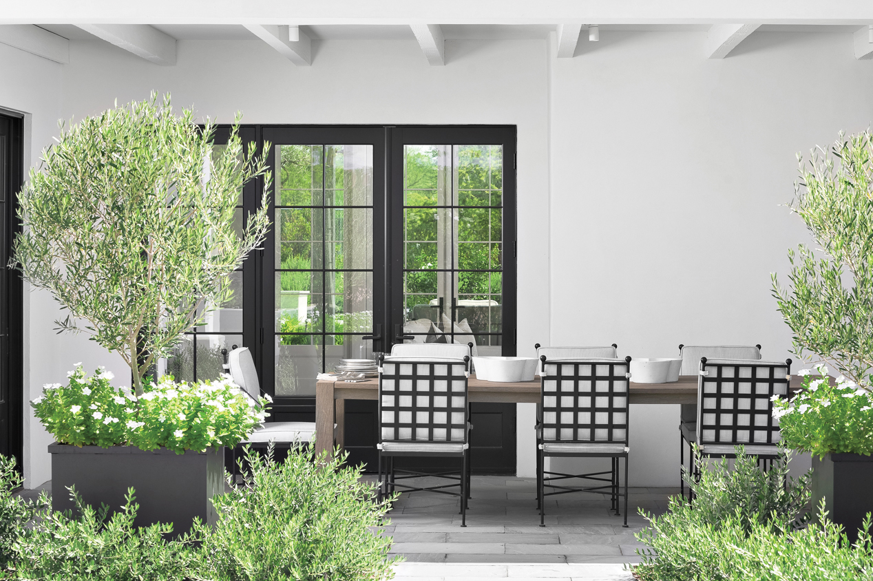 An outdoor dining area surrounded by greenery.