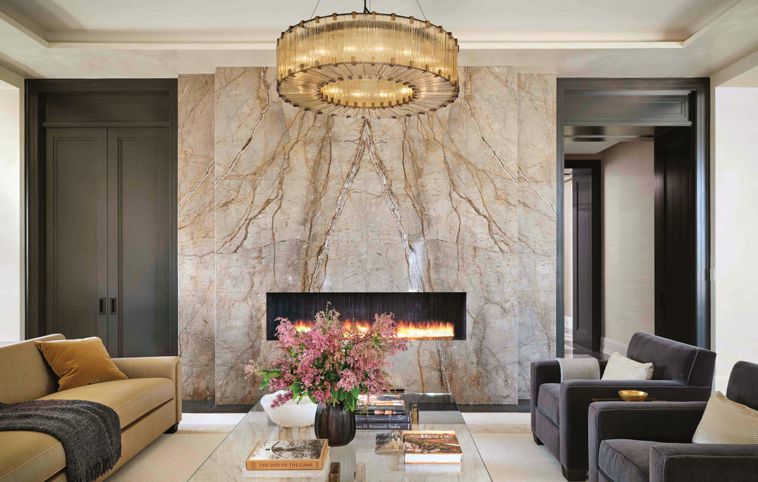 A floor-to-ceiling marble fireplace with...