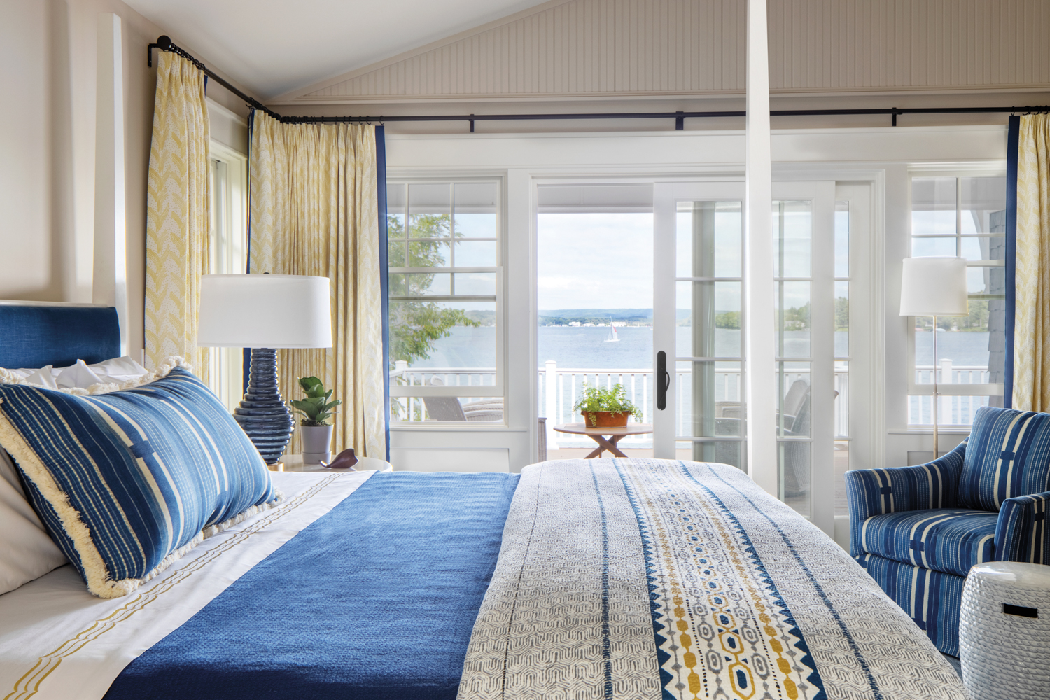 A blue-white-and-yellow bedroom with a...