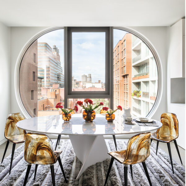 Inside A Groovy NYC Apartment With A Space-Age Twist – Modern White Dining Table With Resin Chairs And Hide Rug