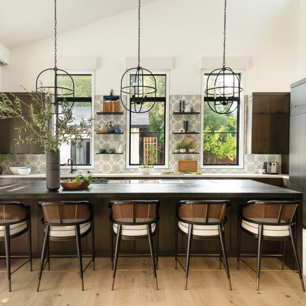 From A Humble 1950s Ranch House To An Elegant Spanish-Inspired Gem Colorful contemporary spanish-inspired kitchen with tile and sculptural pendants