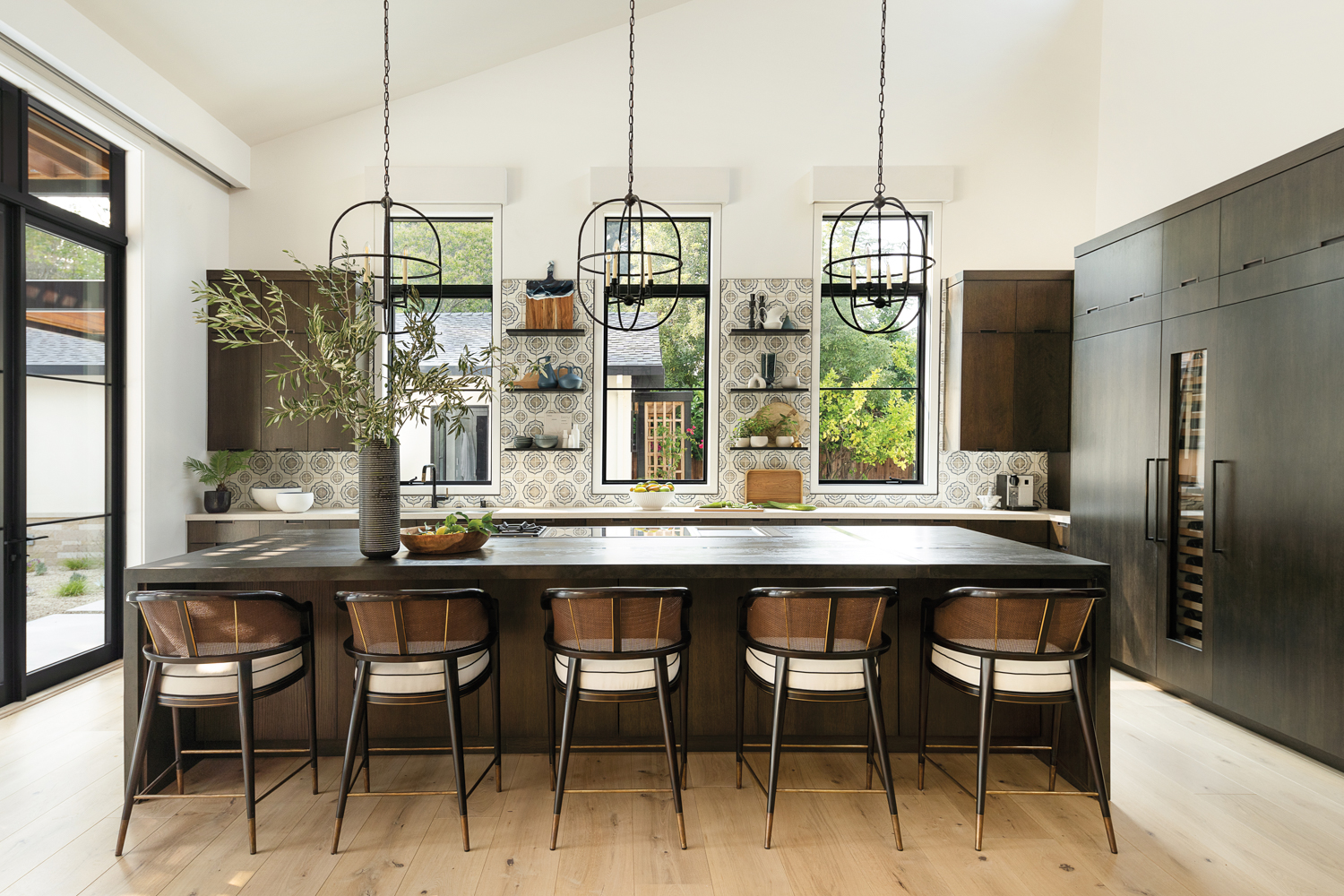 contemporary spanish-inspired kitchen with tile and sculptural pendants