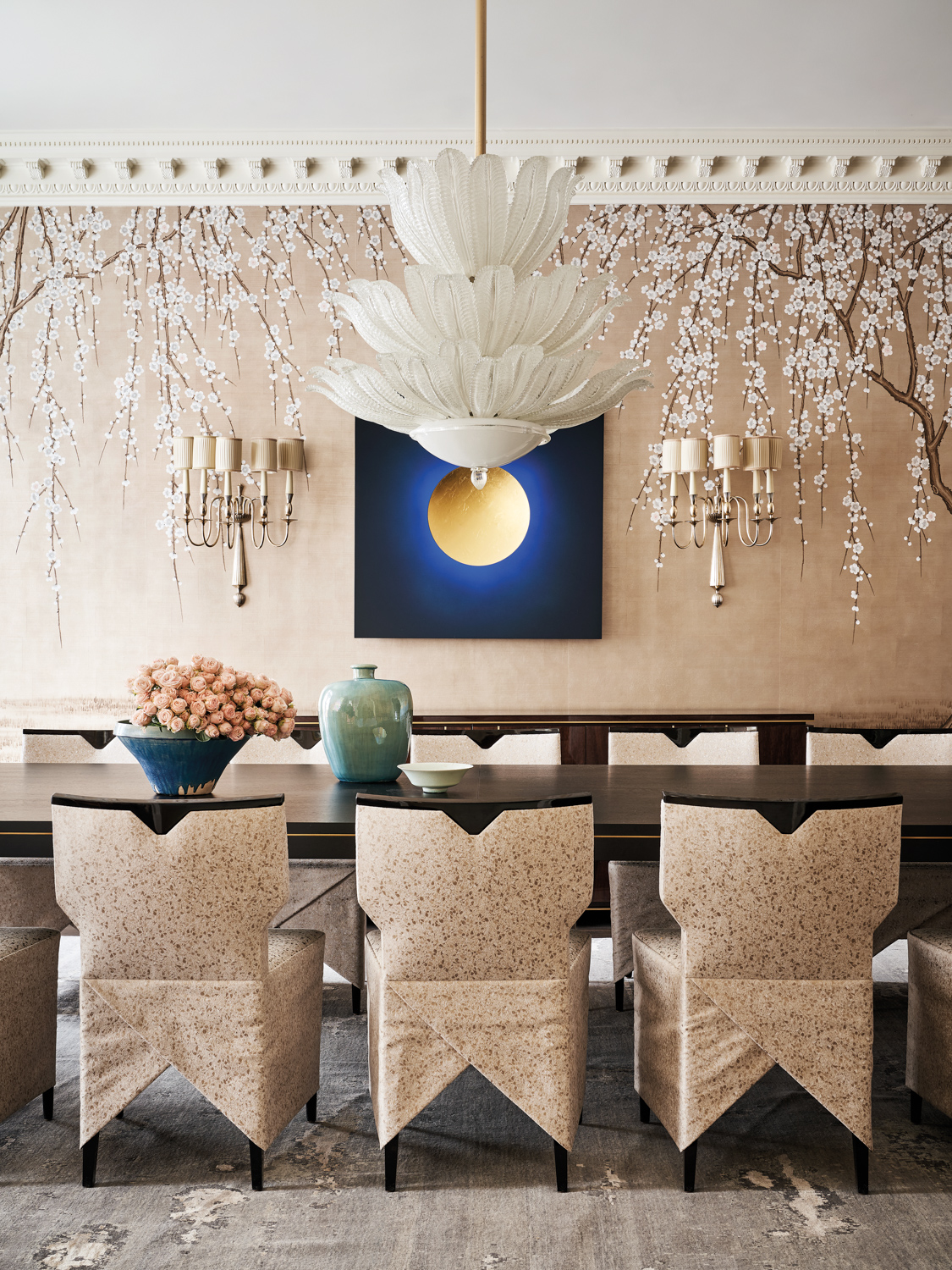 formal dining room featuring a vintage Murano glass chandelier and Art Deco wall sconces