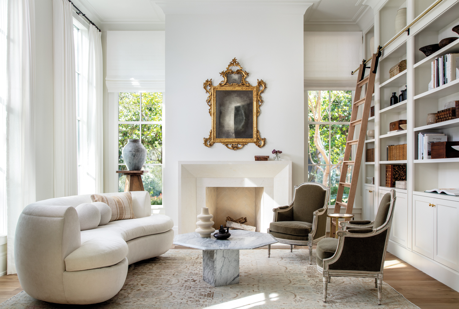 modern white parlor featuring a limestone mantel and antique furnishings