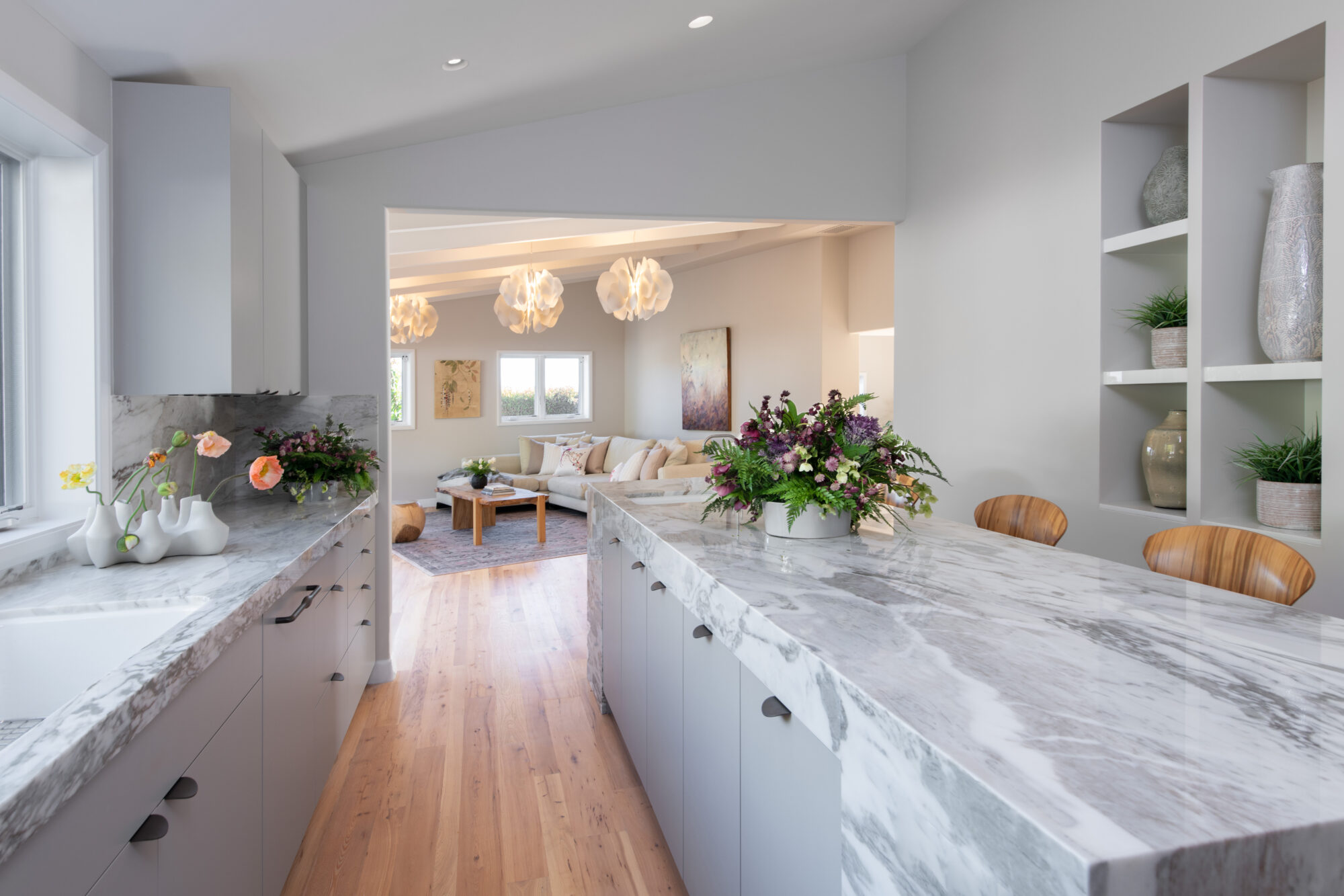 sarah barnard open kitchen with white stone island looking into living area