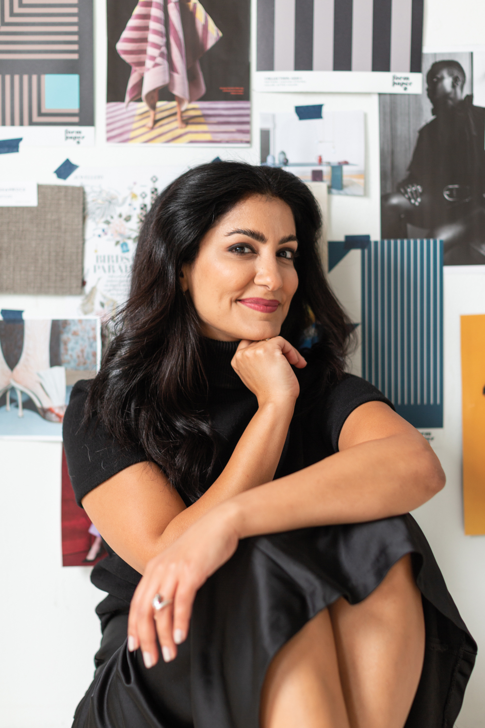 Headshot of designer Dala Al-Fuwaires in front of mood board for form paper co