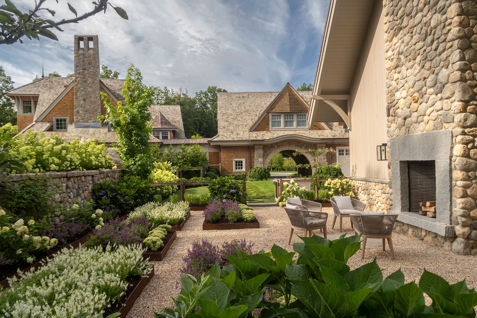 Gracious courtyard garden with raised beds and seating area