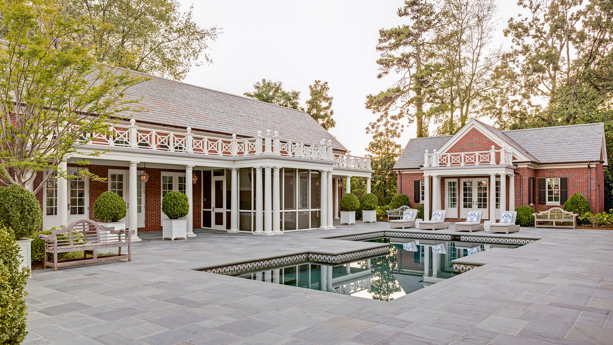 brick courtyard and pool featuring bevolo lighing