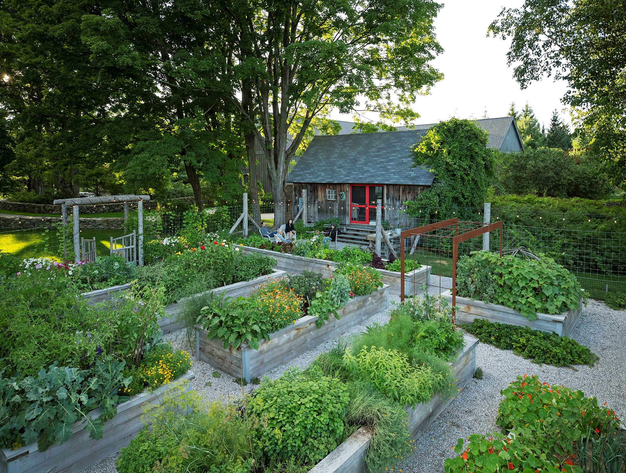 Cottage with raised beds of herbs and vegetables