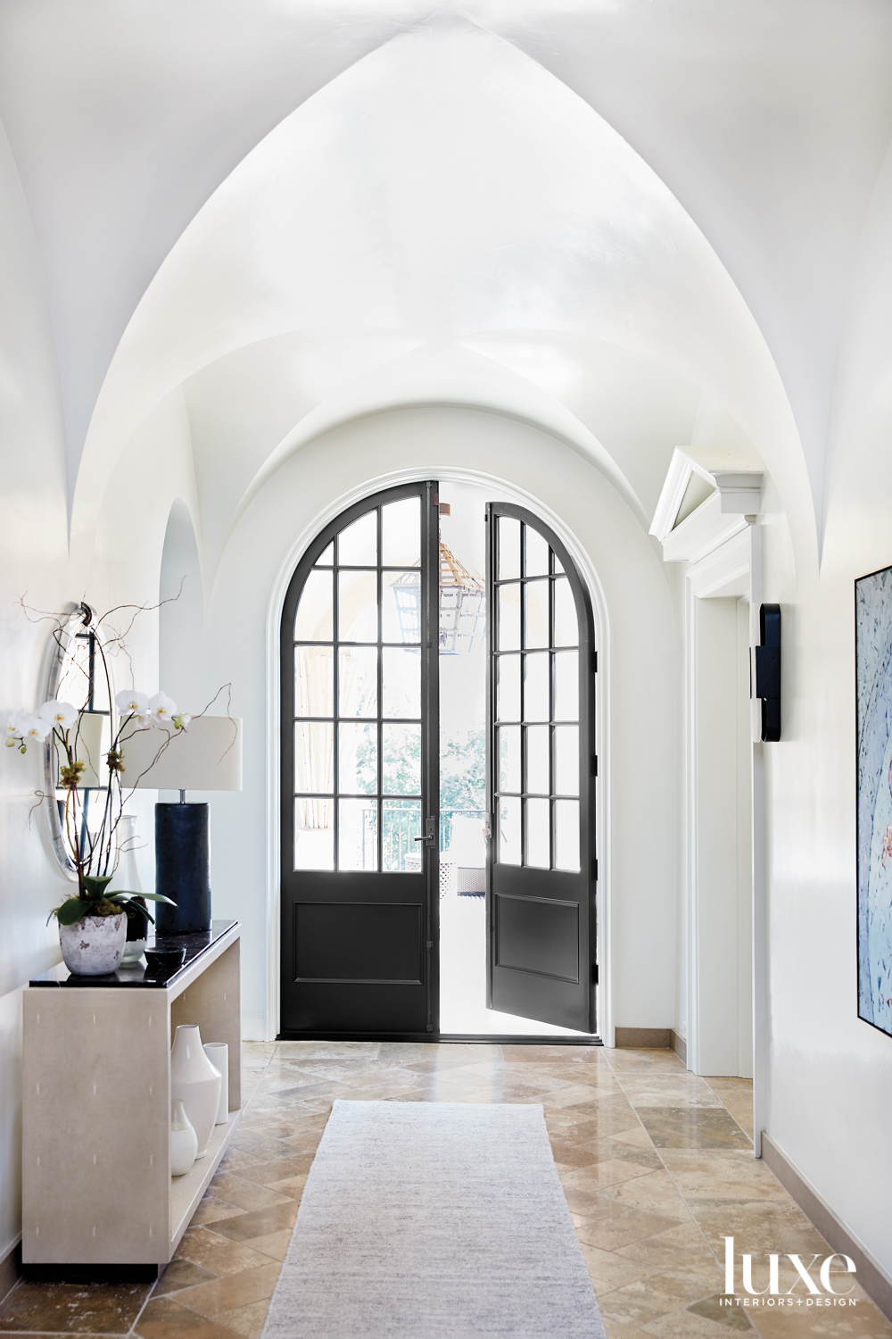 Well-lighted entryway with barrel-vaulted ceiling...