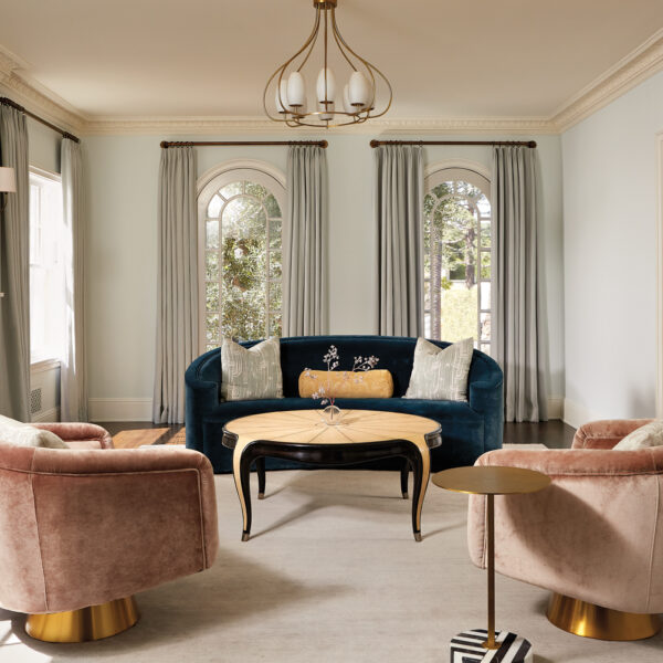 formal living area with curved blue sofa and pink swivel chairs and French style coffee table