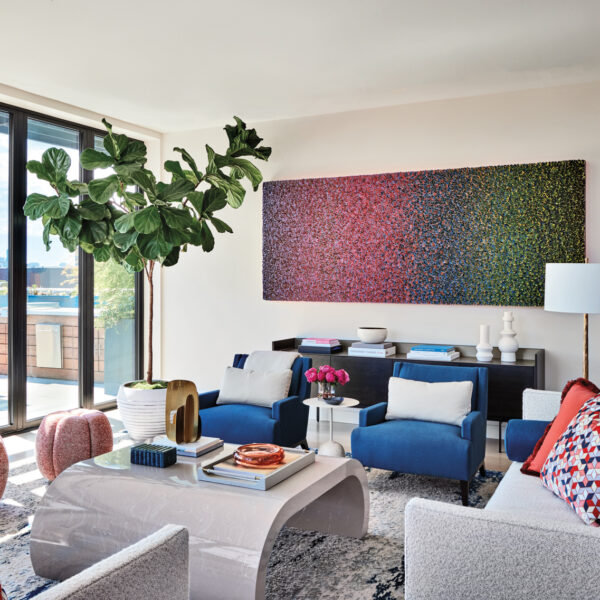 A Serene Chicago Penthouse Made For Summer Embraces The Outdoors Living room with large, colorful abstract painting and two blue armchairs