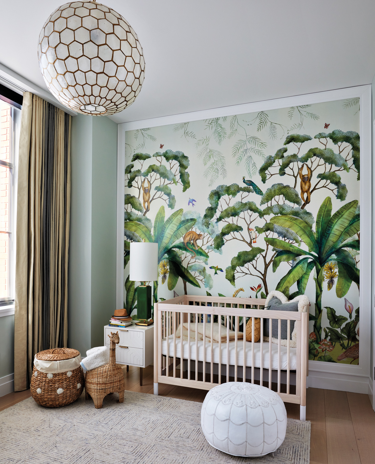 Nursery with a crib, jungle-themed...