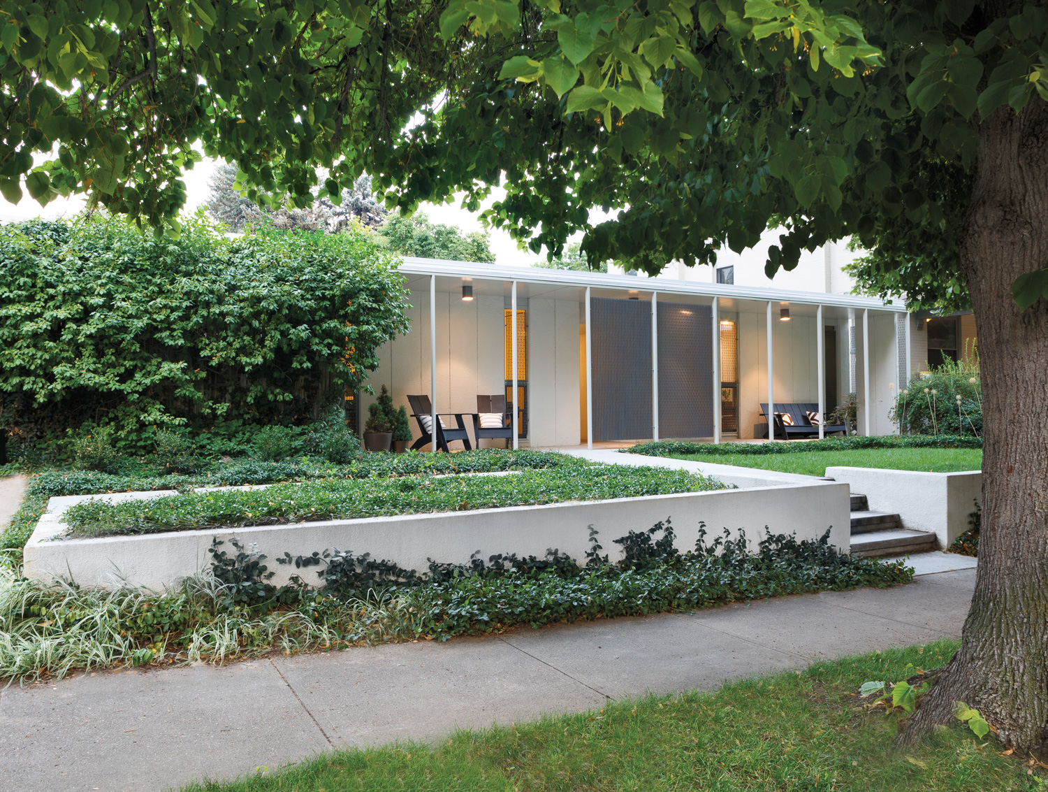 façade of this midcentury modern home with slender windows and front deck area