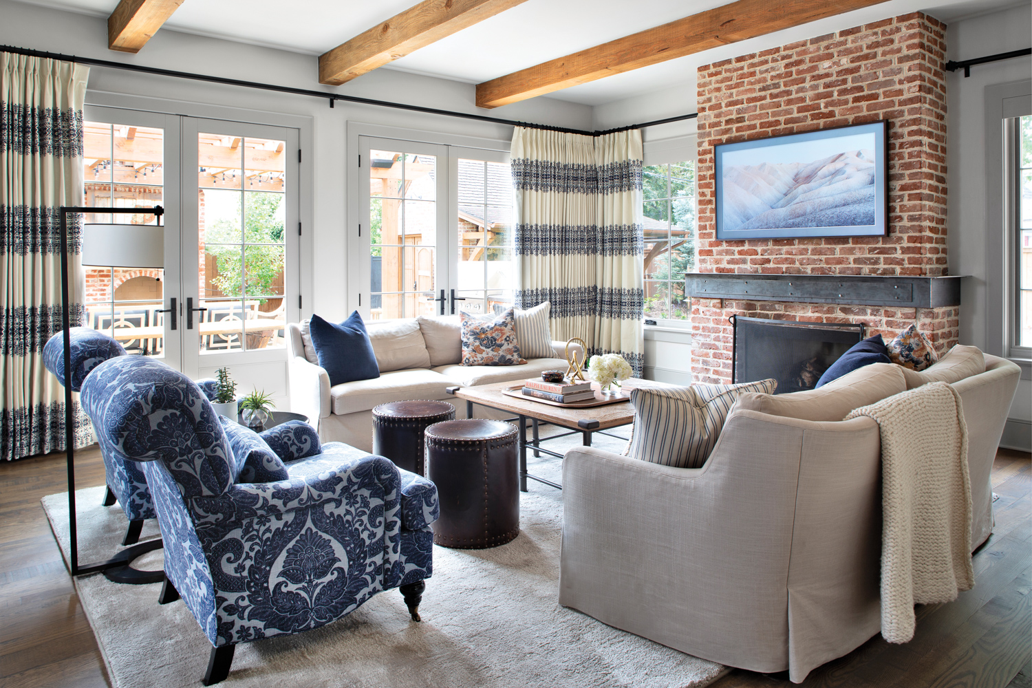 family room with exposed beams,...