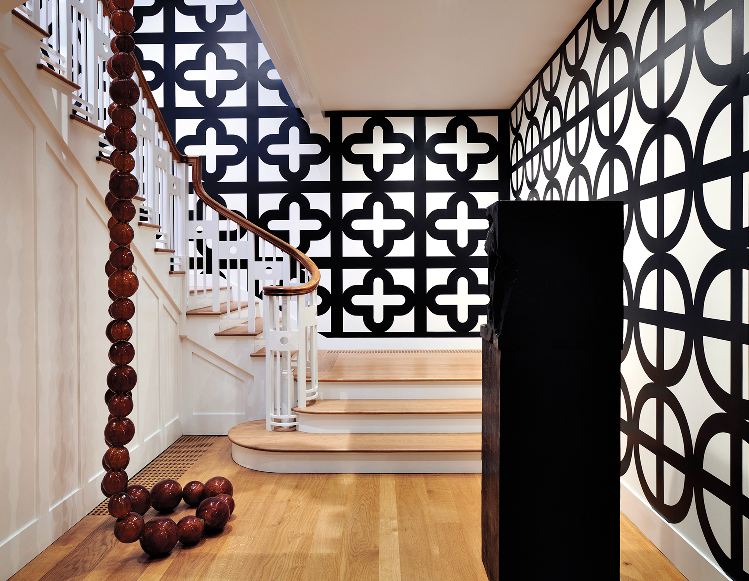 art gallery staircase with patterned art on walls