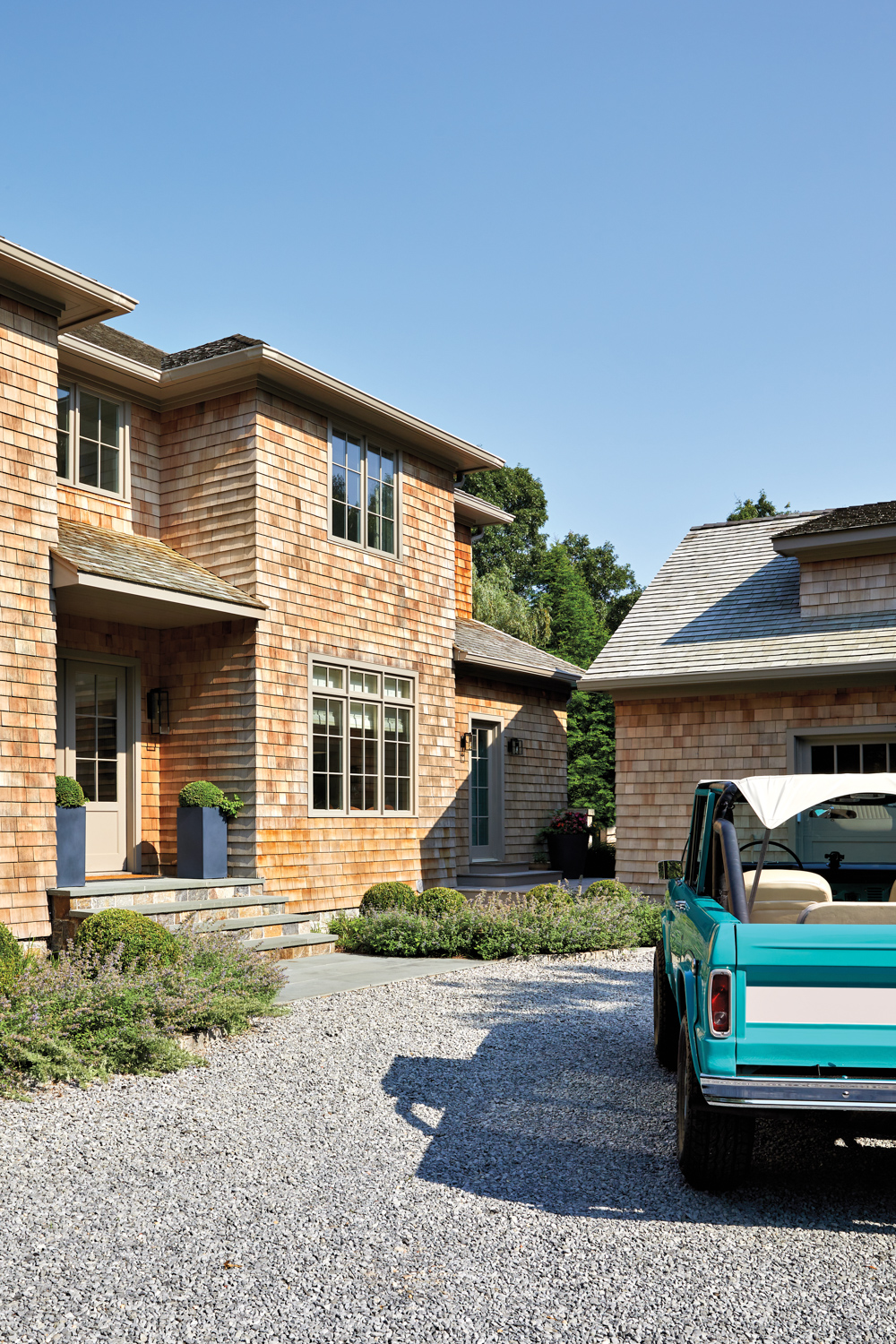 wood-shingled home exterior with turquoise...