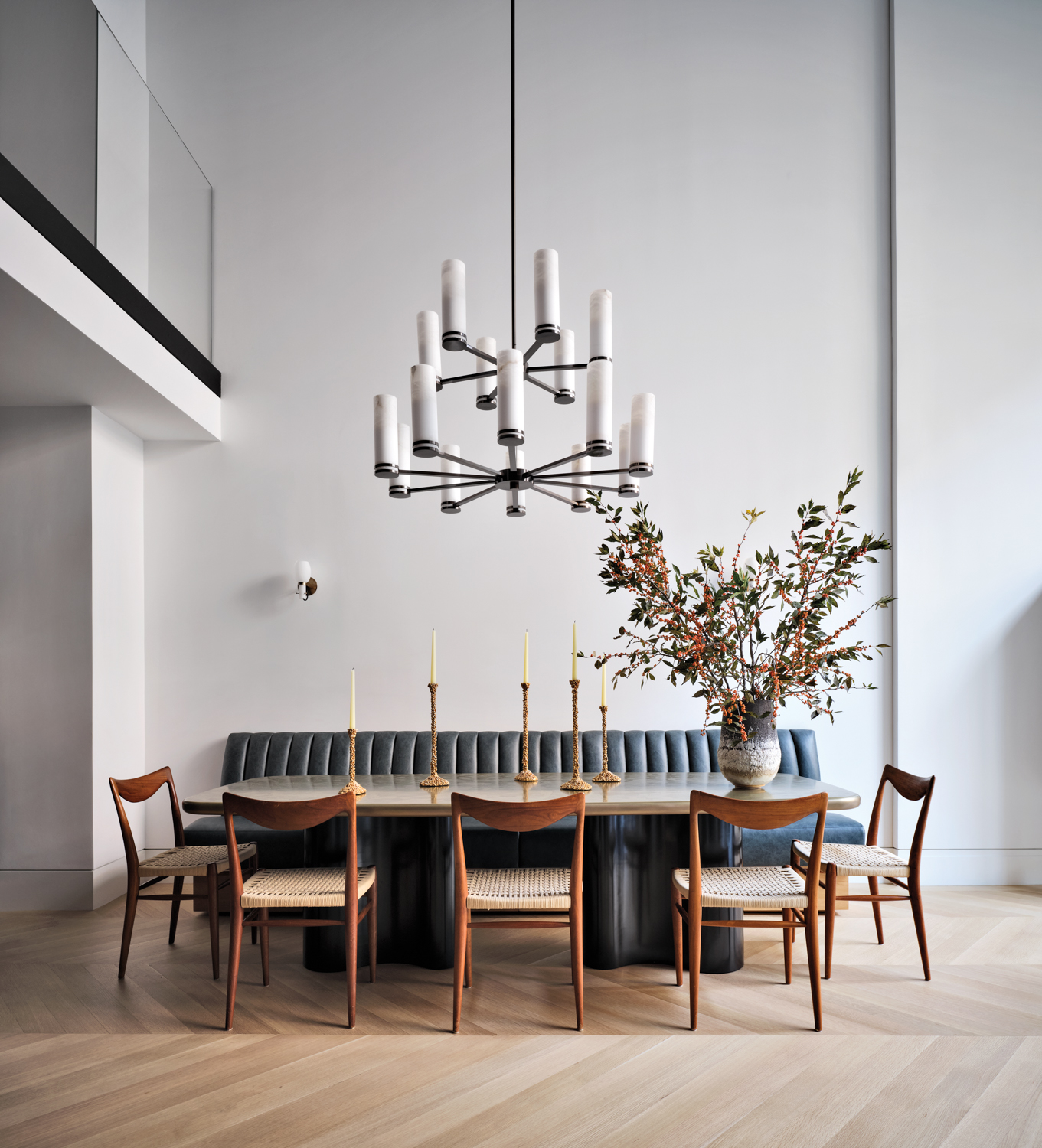 contemporary gray dining room with leather banquette and midcentury style wood chairs